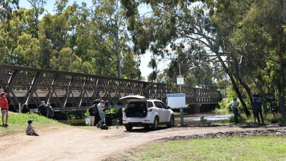 MEDIA IN TOWN: All eyes on the water level at the Forbes Iron Bridge on Tuesday. Picture: Jenny Kingham