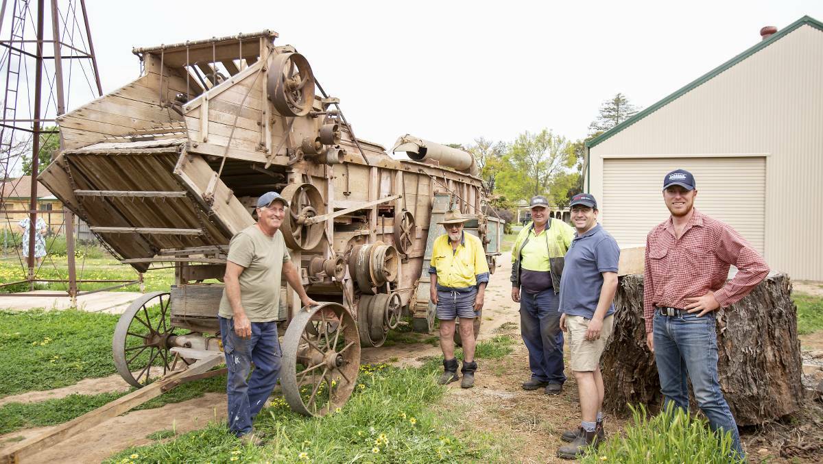 Ray Agustin, Peter Slaven, Sean Haynes and Brendan Mainsbridge with the thresher recently moved to the museum. Photo by Kim Storey.