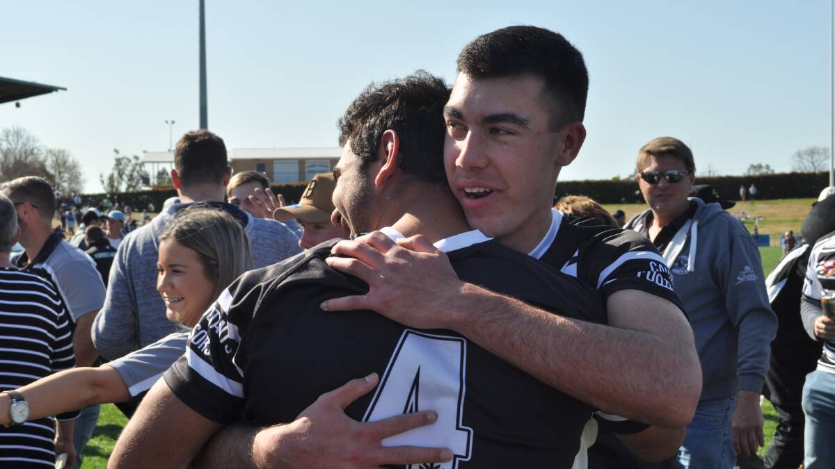 HUGS ALL ROUND: Forbes fullback Charlie Staines after winning the under 18s grand final alongside skipper Aaron Mawhinney. Photo: NICK McGRATH