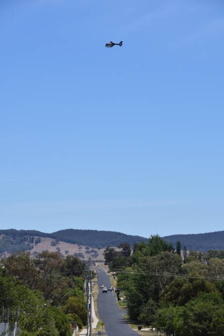 AERIAL PURSUIT: A Polair helicopter flies above Mudgee searching for wanted man Ben Biffin. Photo: HONOR ELLIOTT