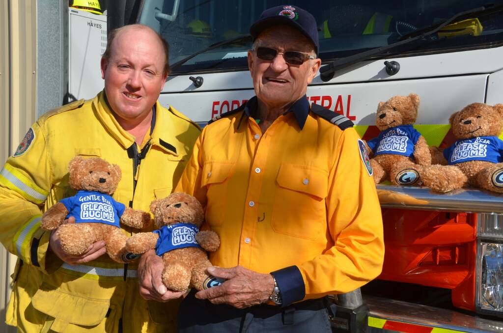 Treasurer Andrew Rawsthorne and Senior Deputy Captain Ron Hocking from Forbes Central Brigade with some of the Gentle Bears provided to the Mid Lachlan Rural Fire Service.