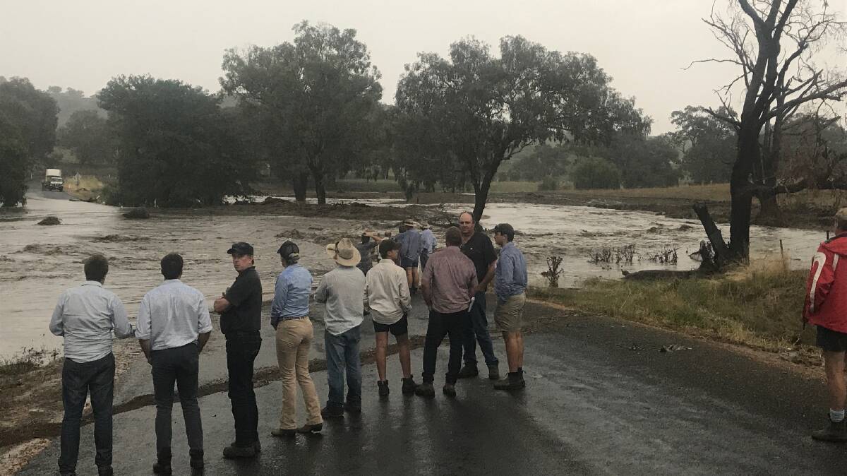A group of wool producers are blocked from crossing a small culvert near Cowra earlier this month after a storm. Landholders lacking groundcover could not prevent soil loss after the deluge.