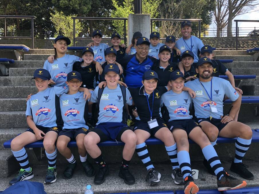 LEARNING EXPERIENCE: Central West's under 12s following a training session in Japan, with Kids' Rugby World Cup tournament manager 'Gotcha' (middle). Photo: WILL GADEN