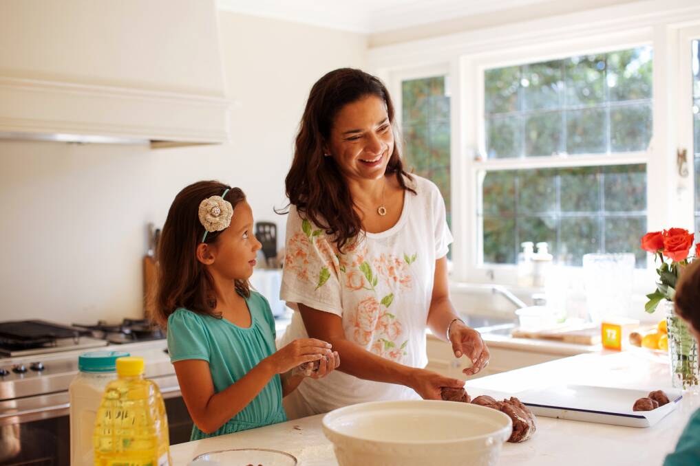 BAKING AWAY: Manildra Group Director Caroline Honan with daughter Laila baking hot cross buns with The Healthy Baker flour. Photo: SUPPLIED
