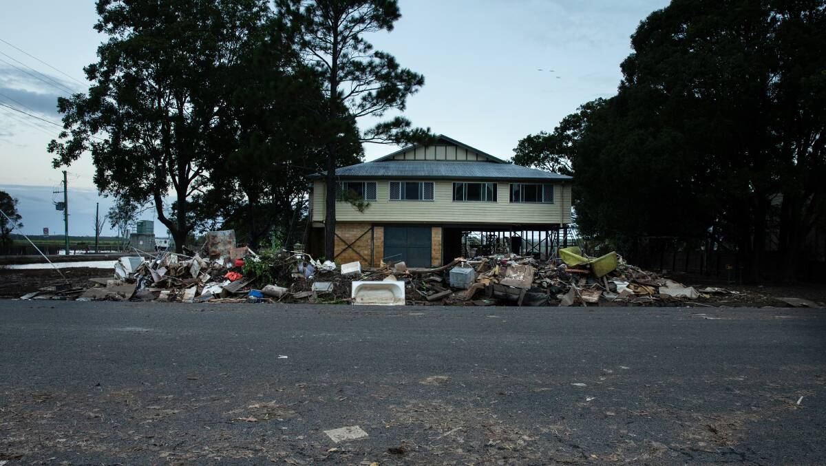 A home on Richmond Street, Woodburn in April. Its flood-damaged contents are piled up on the nature strip. Picture: Marina Neil