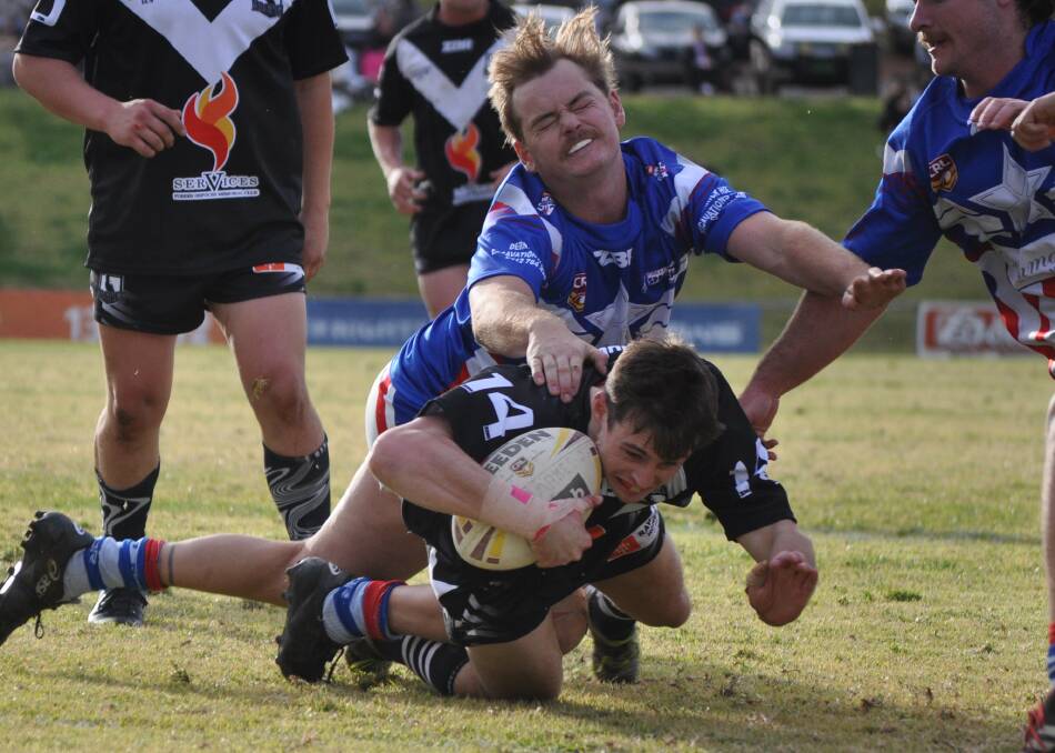 GET THERE: Jaiden Burke dives across to score a try for the Forbes Magpies in last year's bumper long weekend derby clash with the Parkes Spacemen. Photo: NICK McGRATH