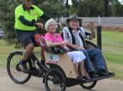 ALL SMILES: Peter Guppy from Cycling Without Age Parkes takes Pat and Ray Wilson for a trishaw ride last weekend. You can take a ride from Lions Park on Wedneday and Saturday mornings. Photo: KRISTY WILLIAMS.