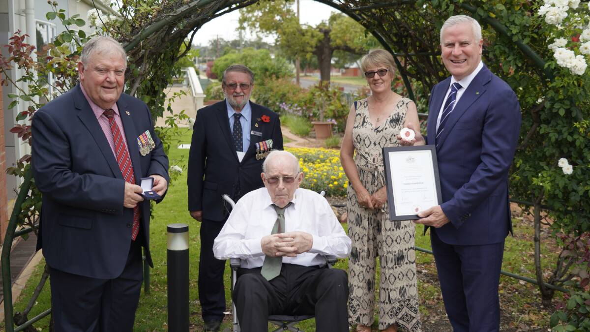 WWII medal: Paul Thomas, Keith Woodlands, Thomas Forrester, Narelle Sunderland and Deputy PM Michael McCormack with Thomas' medal and certificate. Photo: Supplied.
