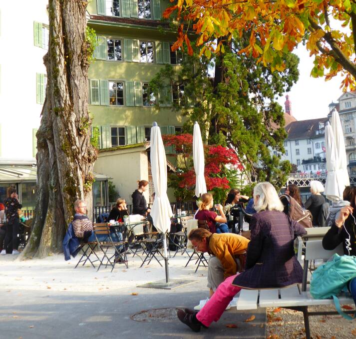 ON EASY STREET: Tourists and locals alike bask in the sunshine of Lucerne's lively squares. 