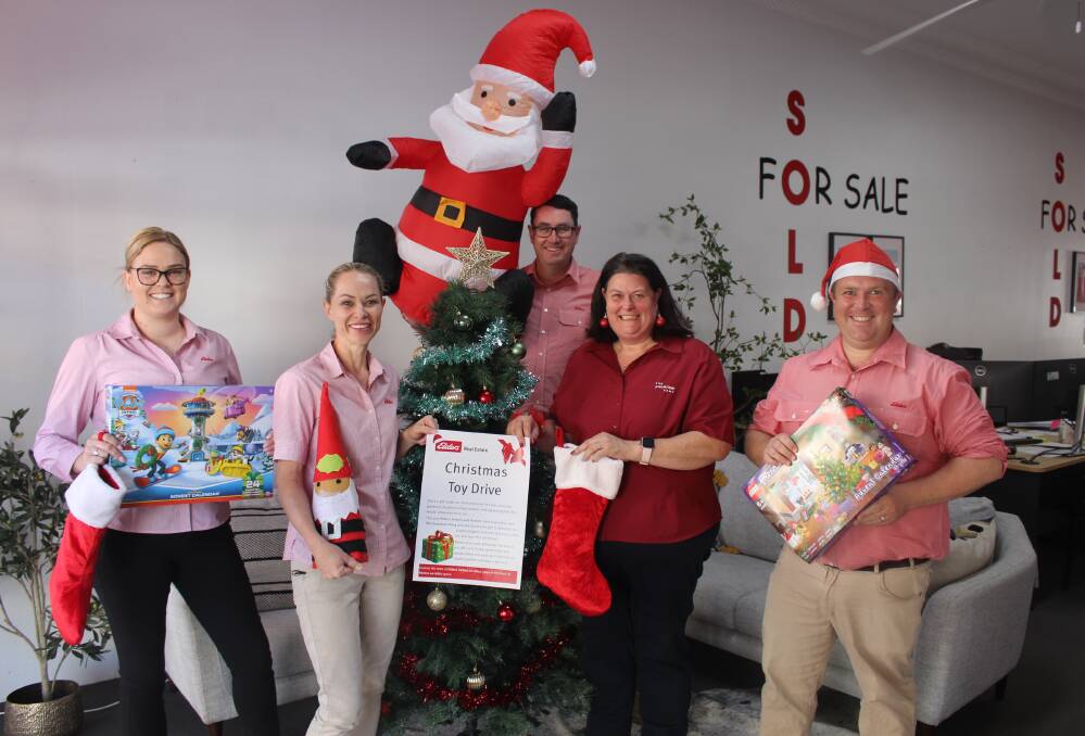 Elders Real Estate's Maddie Woodbridge, Emma Henderson, Ian Simpson and John Ilchef join the Salvation Army's Major Sandra Walmsley in promoting their Christmas appeal.