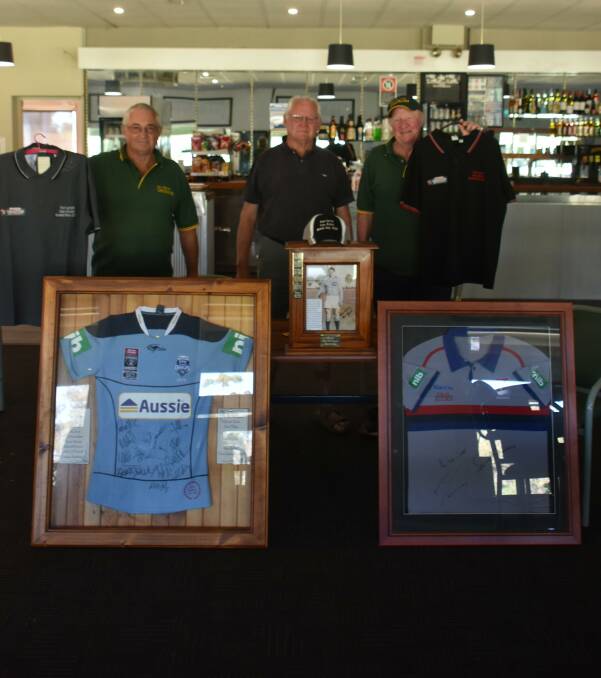 CanAssist's John Schrader and Kerry Dunstan with Forbes Bowling Club's Norm Cook with some of the things they will be auctioning at the Ron Lynch Bowls Day.