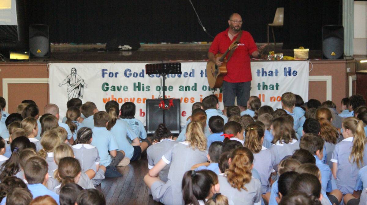 Guest presenter Reverend Andrew Parkinson engaging the students at the Combined Schools Scripture Christmas Celebration.