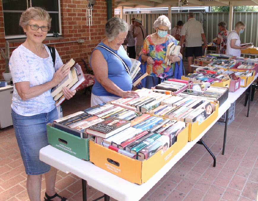 Some ladies pick through books for purchase like many will at an upcoming book sale. Picture: Supplied