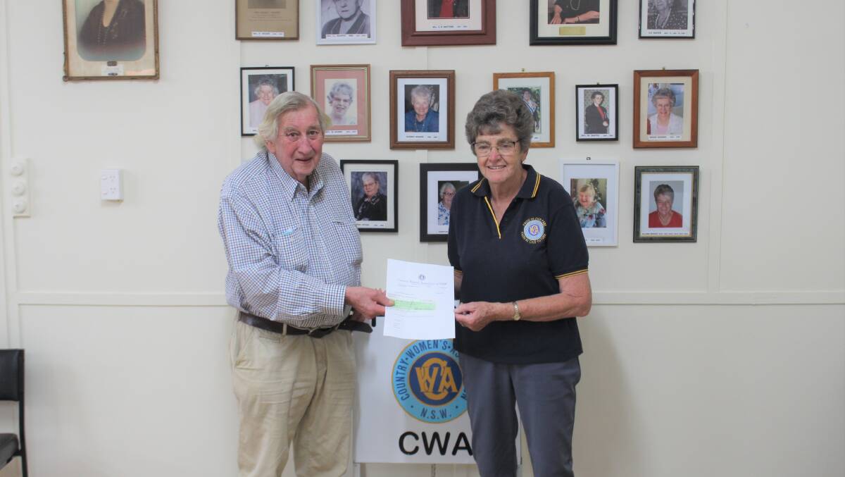 Ray Davey from the Forbes Apex Over 40s group presented the $220 checque to Forbes CWA's Elaine Bright.