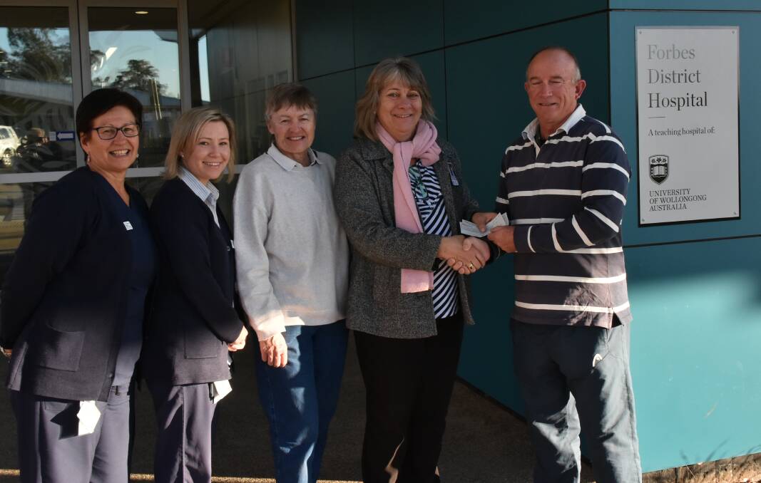Peter Clifton (right) and Heather Davidson (centre) presented Cheryl Brown. Kay Sheiles and Liz Mitchell from the Hospital with the $3850 raised at the tennis Club's charity fun day.