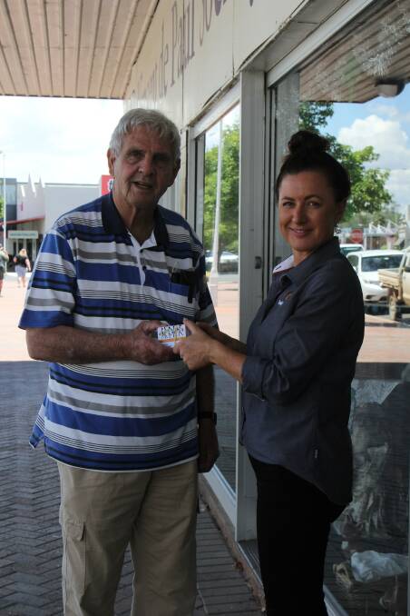 Cowal Gold Operations Community Relations Officer Renee Pettit presenting the $5000 in Why Leave Town Cards to Forbes Vinnies President, Vince Toohey.