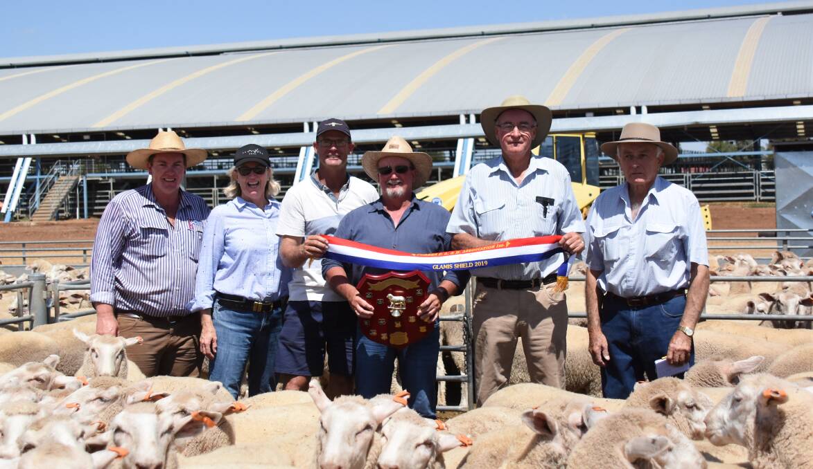 Geoff Jones from Troff Pastoral is congratulated on winning the Glamis Shield in 2019 by Adam Chudleigh, Jenny Bradley, Murray Brown, Barry Harper and Norm Haley.