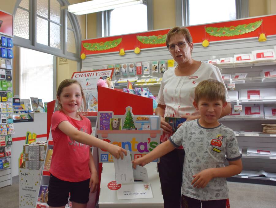Sophie Morrison and Nate Molloy were mailing their letters to Santa with the help of Post Office manager Ruth Howarth.