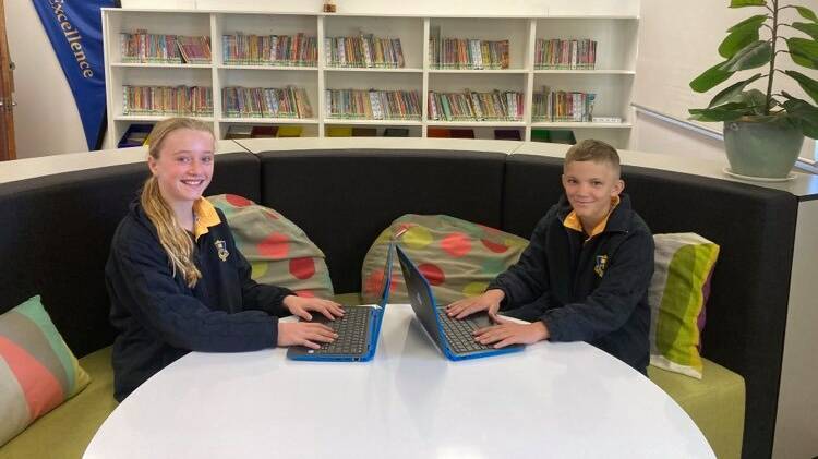 Claudia Hodder and Stirling Francis with the new laptops.