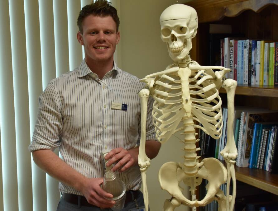 Medical student Dominic Sellers with a spacer and an inhaler, common instruments which help relieve asthma symptons.