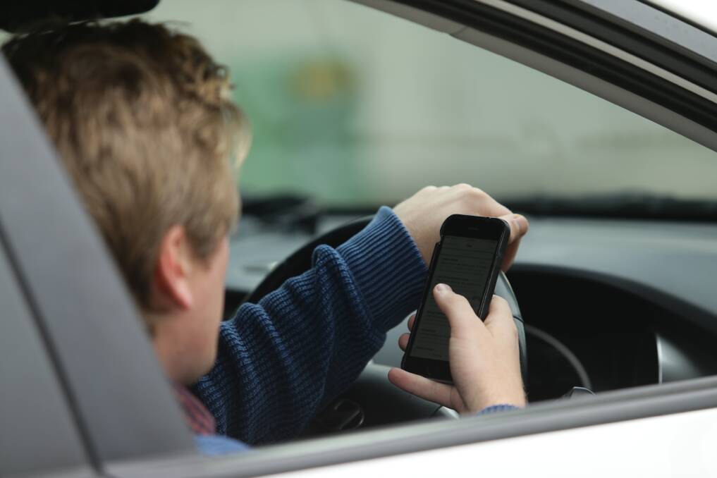 Cracking down: The AMA believes introducing harsher penalties for mobile phone use could help change driver behaviour. Photo: FILE