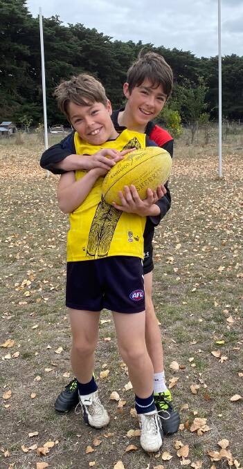 HOLDING THE BALL: Draffen brothers Josiah, 13, and Levi, 11, on their family's own football ground at Ellerslie. 
