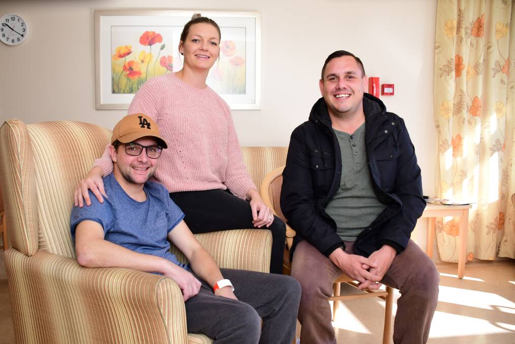 IMPROVING: Jockey Michael Hackett with wife Lee and friend Ben Smith in Lourdes Hospital, Dubbo, where he is recovering. Photo: BELINDA SOOLE