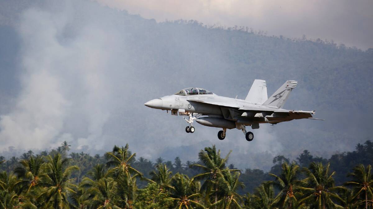 An Australian F/A-18F Super Hornet lands during a joint Australian-Indonesian exercise in Sulawesi last year. The F/A-18F Super Hornets will carry new missiles. Picture: Colin Dadd, Defence