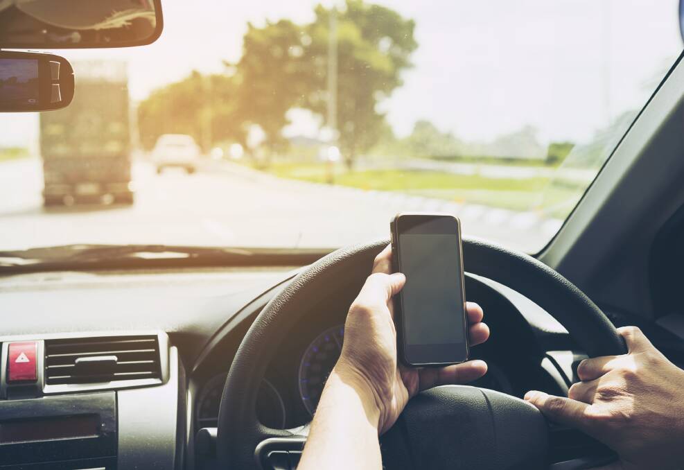 Dangerous distraction: Using a mobile phone while driving is illegal in NSW resulting in fines up to $439 and the loss of 4 demerit points. Photo: Shutterstock.