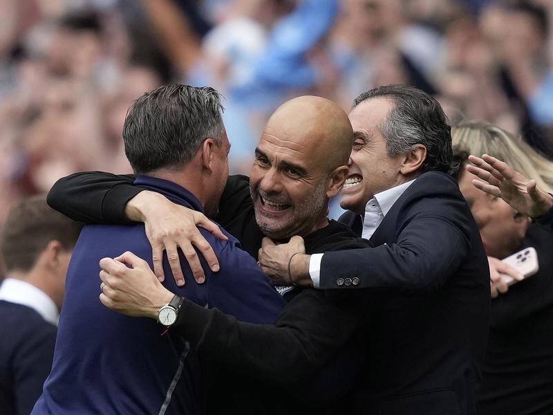 Manchester City's manager Pep Guardiola (c) celebrates after winning the Premier League.