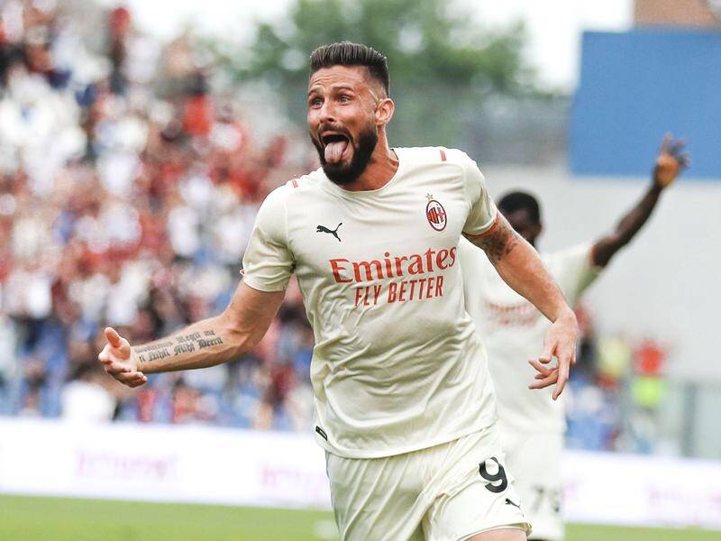 Olivier Giroud celebrates the second of his two goals that clinched the Serie A title for Milan.