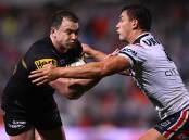 Penrith's Dylan Edwards is tackled by the Roosters' Joseph Manu in the Panthers' NRL win.