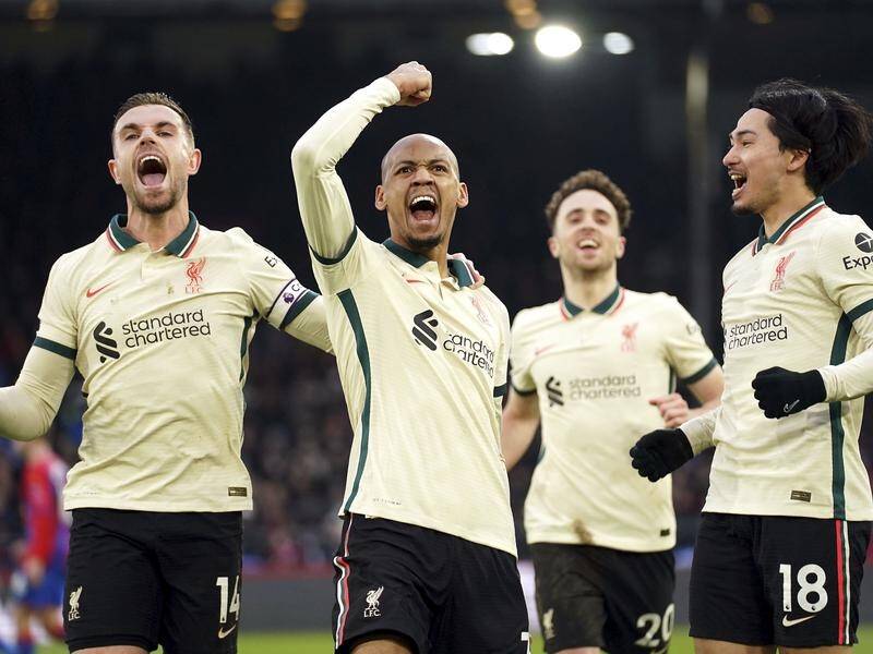 Fabinho raises his arm in triumph after his goal sealed Liverpool's 3-1 victory at Crystal Palace.