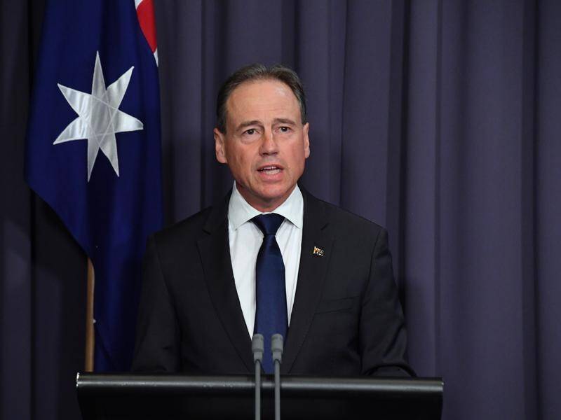 Australia is reviewing the COVID-19 booster timeline due to the Omicron threat, Greg Hunt says.
