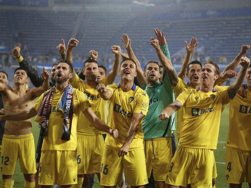 Cadiz players celebrate after escaping relegation from LaLiga by winning 1-0 at Alaves.