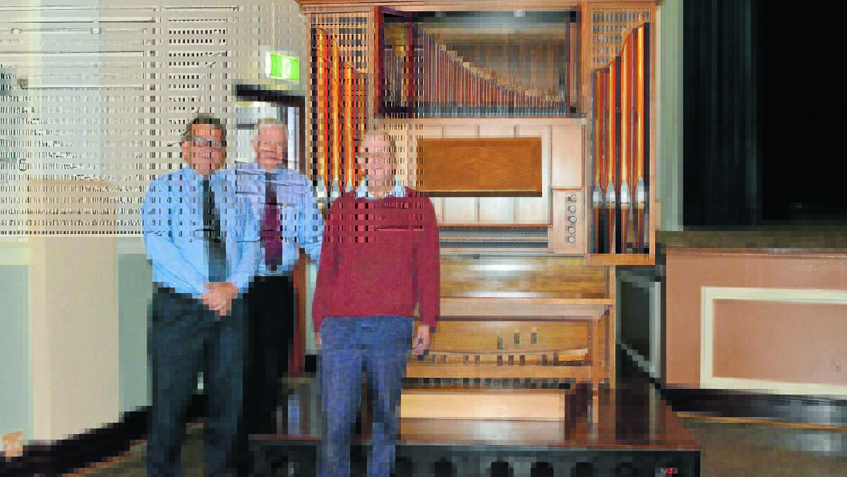 Forbes Shire Council’s general manager Brian Steffen, council’s Richard Morgan and Paul Coles are impressed with the pipe organ in its new location at Town Hall. 0514organ