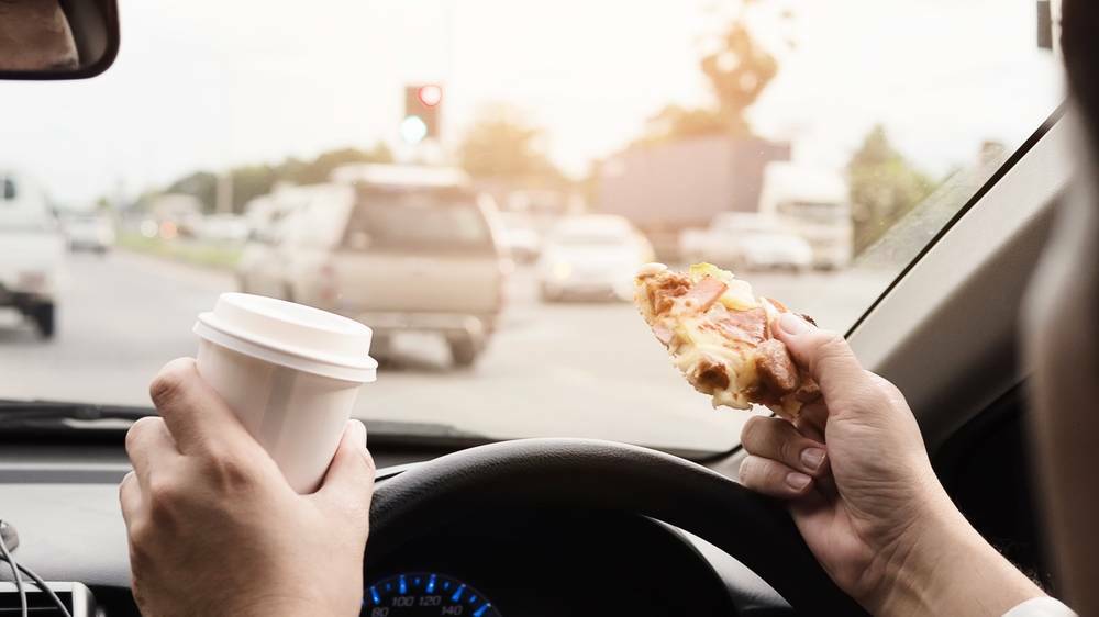 RULE BOOK: Eat and drive and risk three points and a three-figure fine. Photo: SHUTTERSTOCK