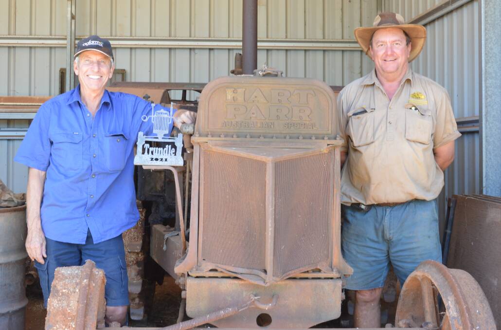 GOOD OLD DAYS: Digger Anderson (left) and Donald Wright (right) with an antique Hart Parr tractor and a prototype of the Tractor Pull trophy.