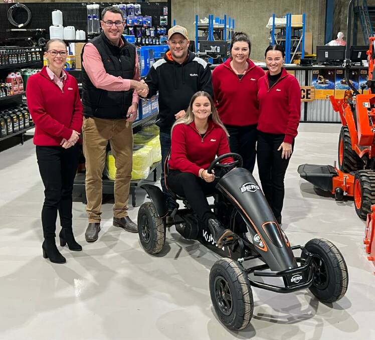 UP FOR GRABS: Emma Henderson and branch manager Ian Simpson from Elders Real Estate in Forbes, Justin Roylance from Roylances Tractor Replacements, and Stacey Myers, Mikala Mongan and Bridie Hughes (front) with the Kubota Berg pedal car that's waiting to be won. Photo: SUPPLIED